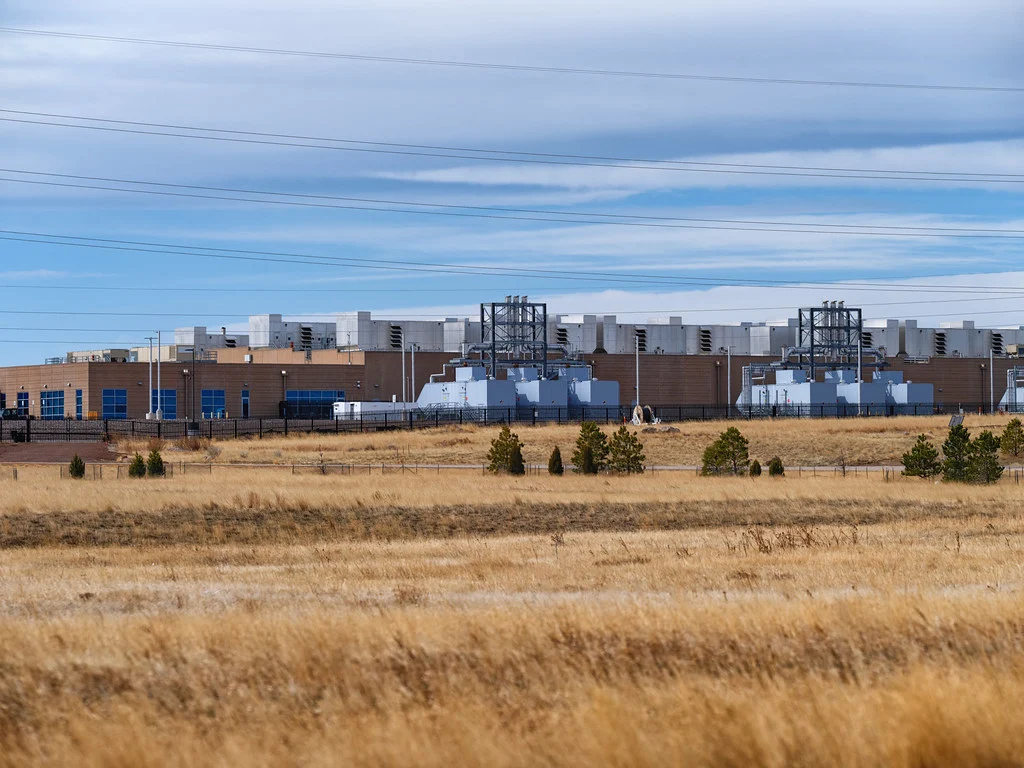 Bâtiment du data center Microsoft à Cheyenne, avec ses installations techniques et un terrain sec au premier plan.