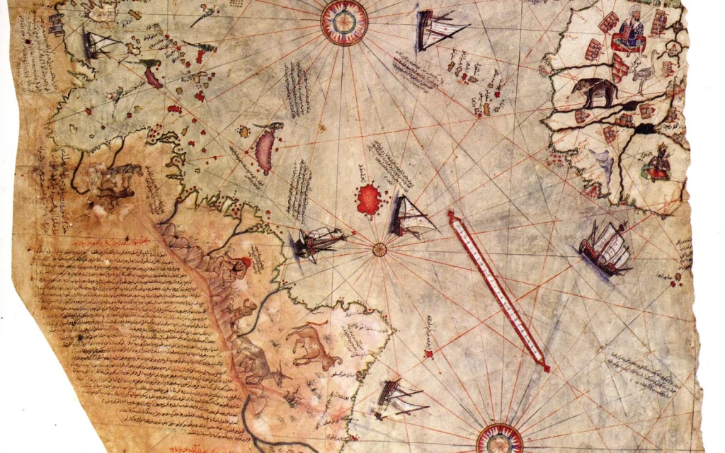 Détail de la véritable carte de Piri Reis de 1513 : côtes de l’Atlantique, navires, roses des vents et annotations manuscrites.